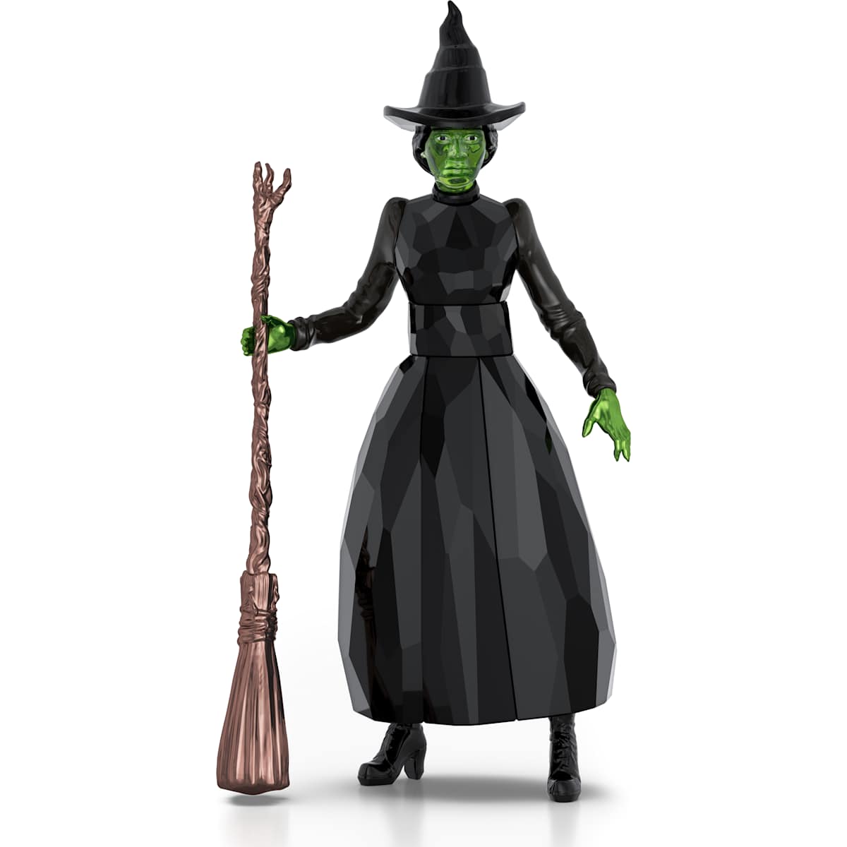 Action figure of a witch with green skin, black outfit, and broom on a white background