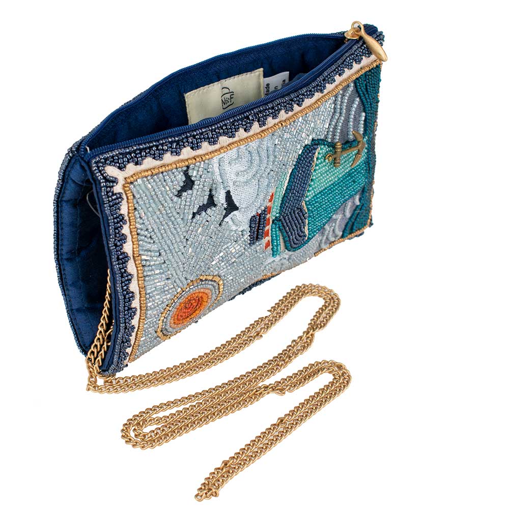 Embroidered clutch bag with gold chain on a white background