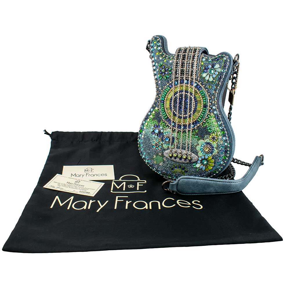 Beaded guitar purse with a black branded pouch on a white background.