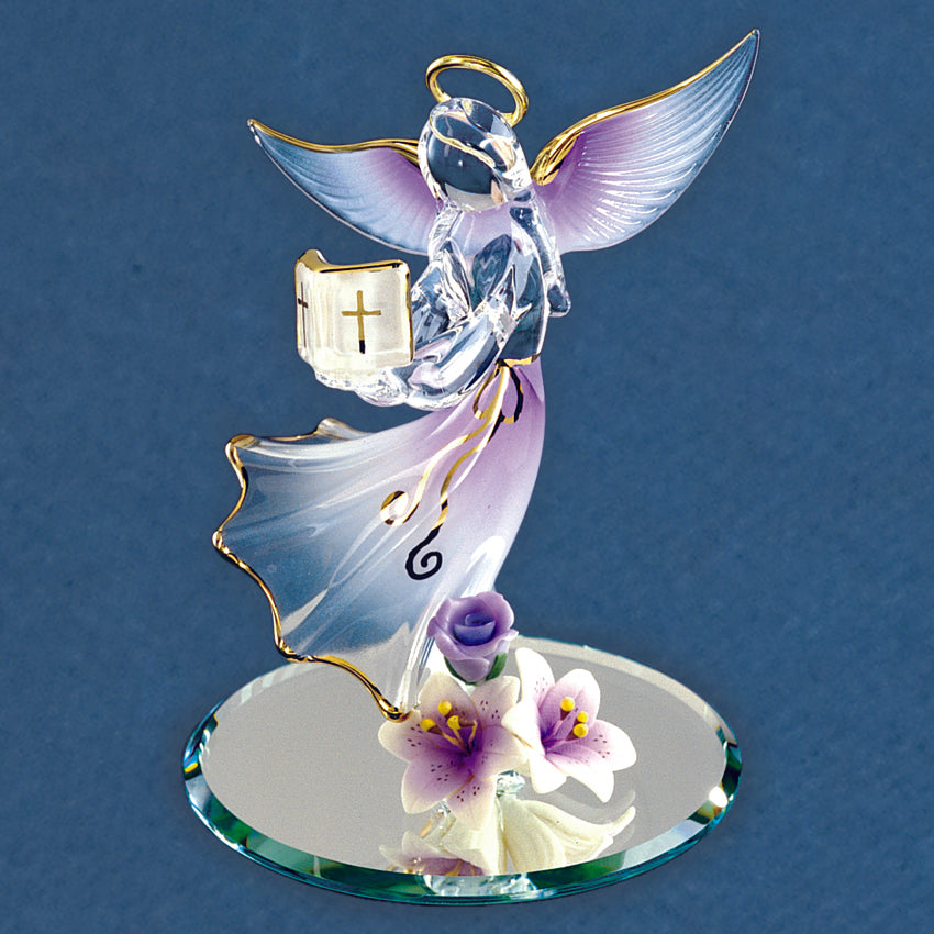 Crystal angel figurine with a cross on a blue background