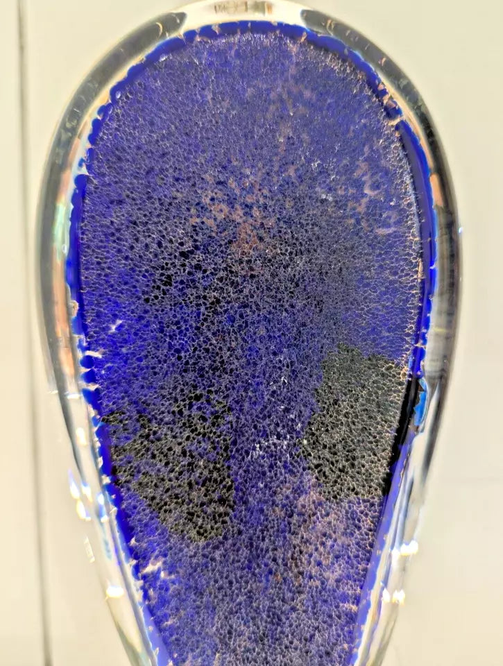 Satava glass jelly fish blue and black textured object against a neutral background back view