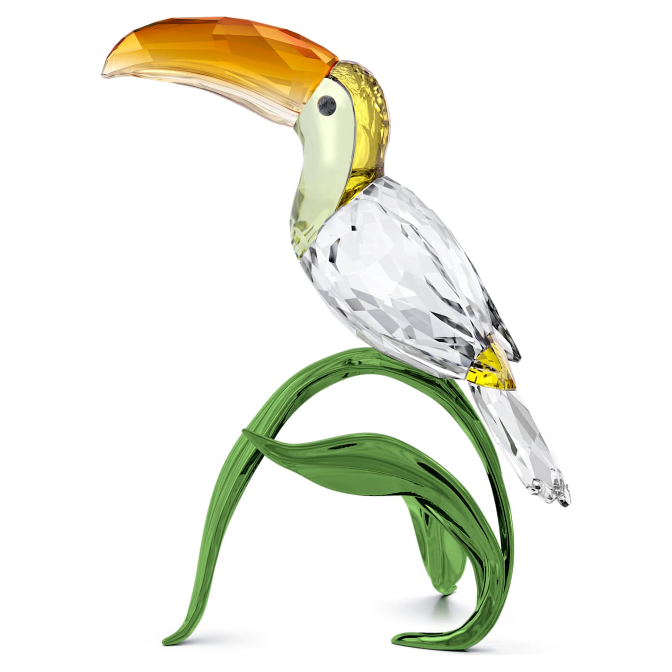 A crystal figurine of a toucan perched on green leaves, made with lacquered metal.