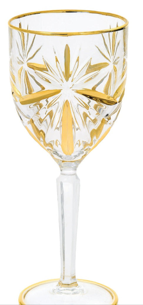 A gold-colored wine glass with a geometric pattern, featuring a star-like shape at the top.