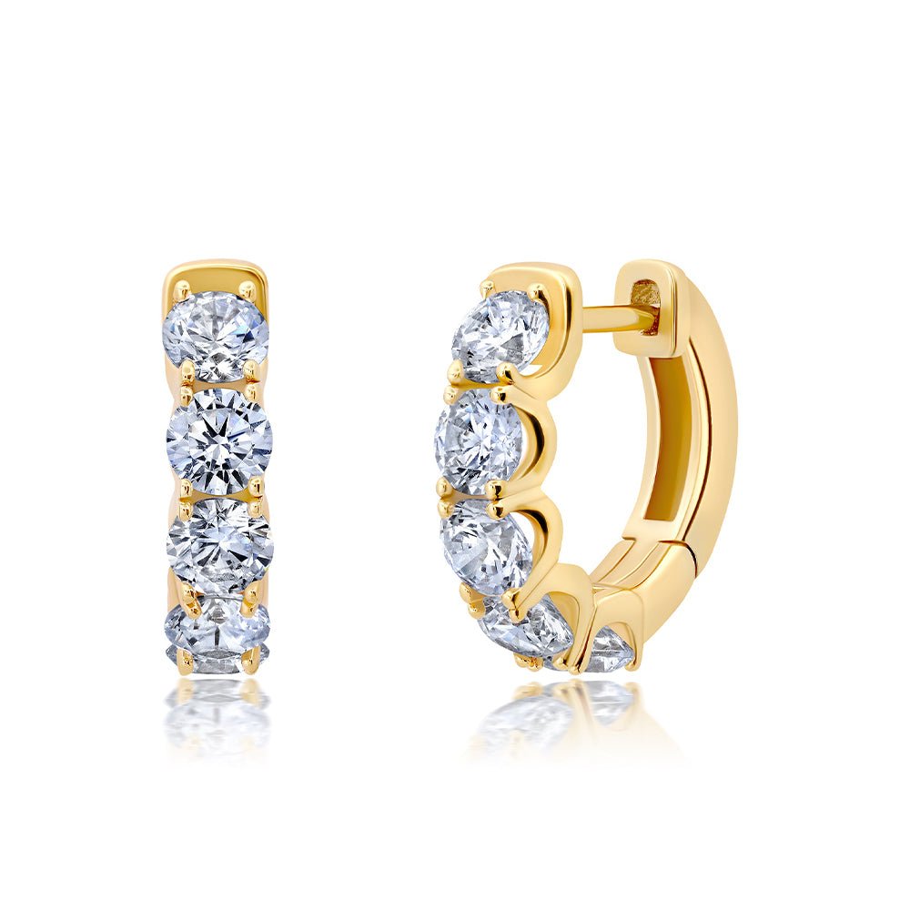 A pair of medium-sized hoop earrings with cubic zirconia inlays, set in yellow gold.