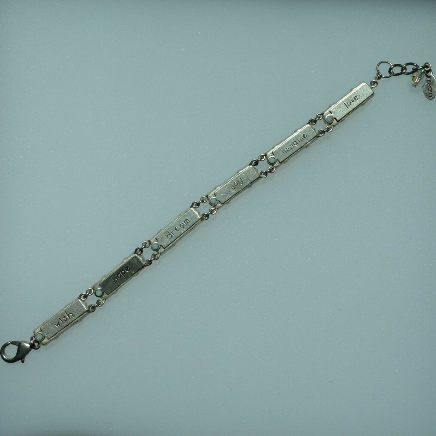 A colorful beaded bracelet with a lobster clasp, in back view.