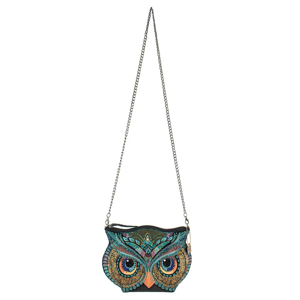 Owl-shaped handbag with chain strap on a white background