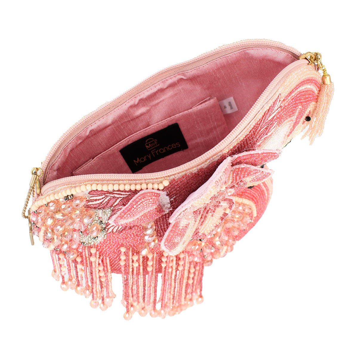 Pink clutch bag with fringe and embellishments on a white background