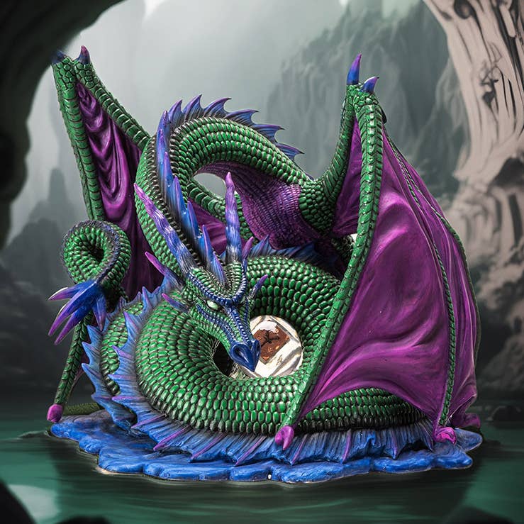 Colorful dragon sculpture with green, purple, and blue hues against a dark background.