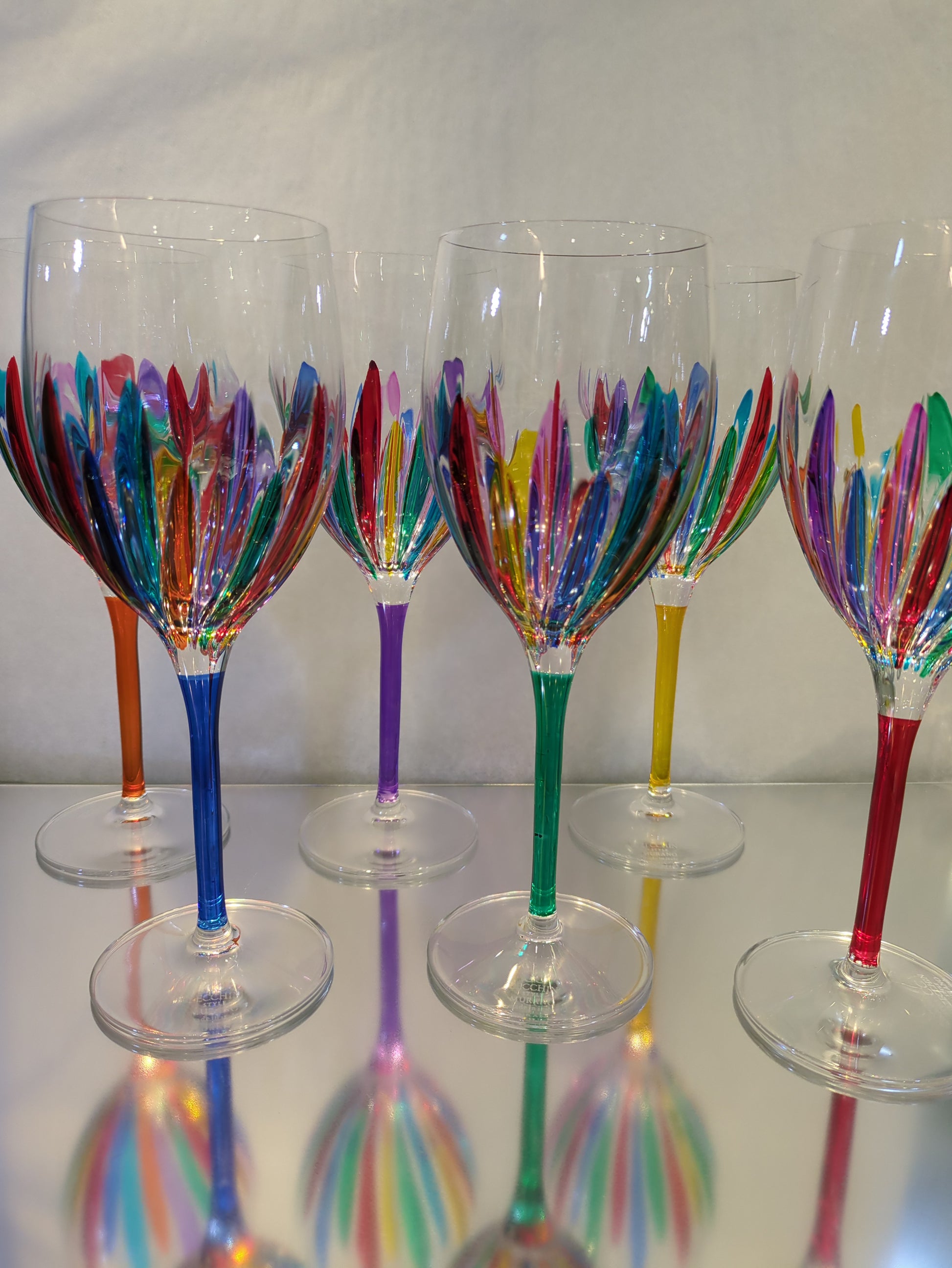 A set of multicolored wine glasses .