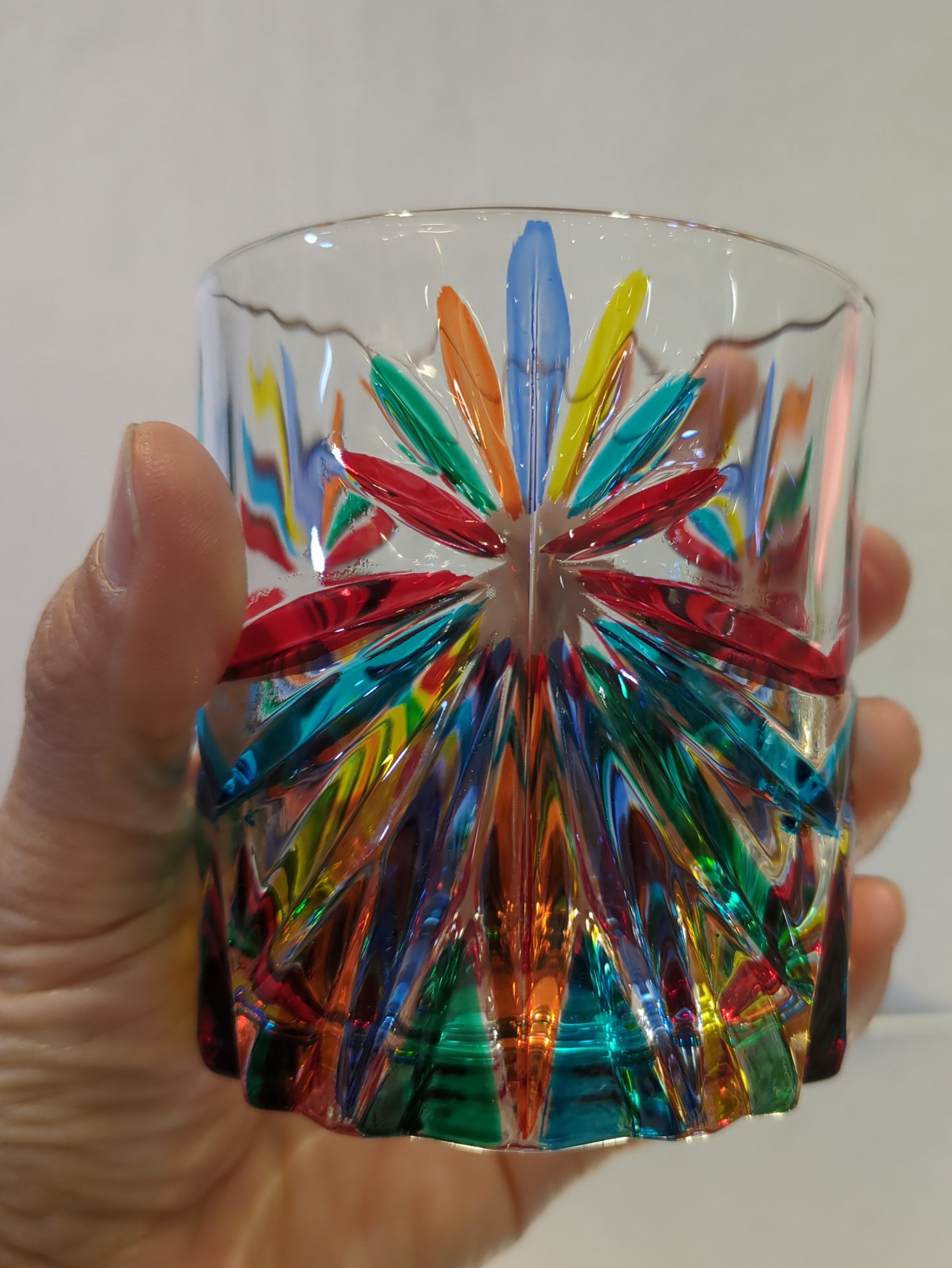 A whisky glass on hand.