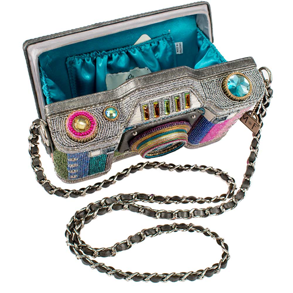 Colorful handbag designed like a camera with a chain strap on a white background