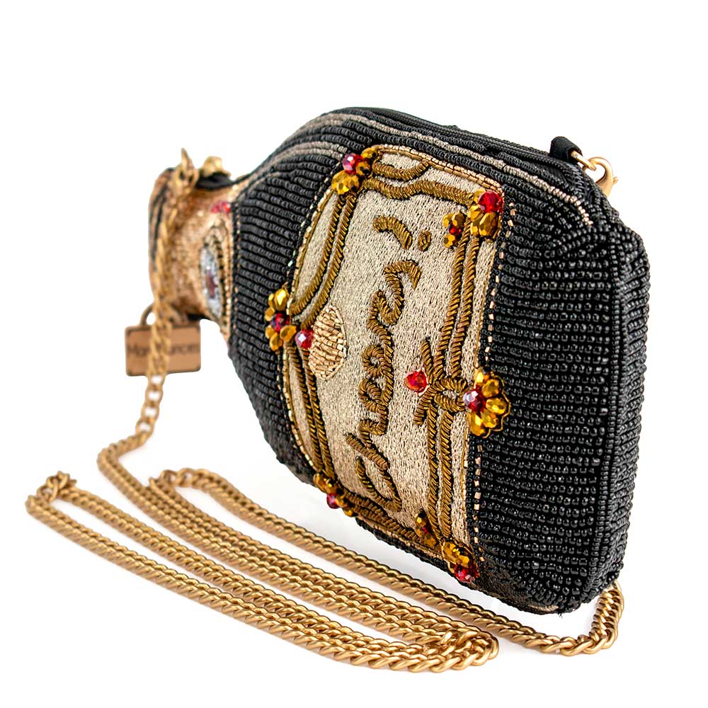 A beaded handbag designed to resemble a champagne bottle of side view.