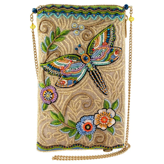 Decorative handbag with dragonfly and floral patterns on a beige background