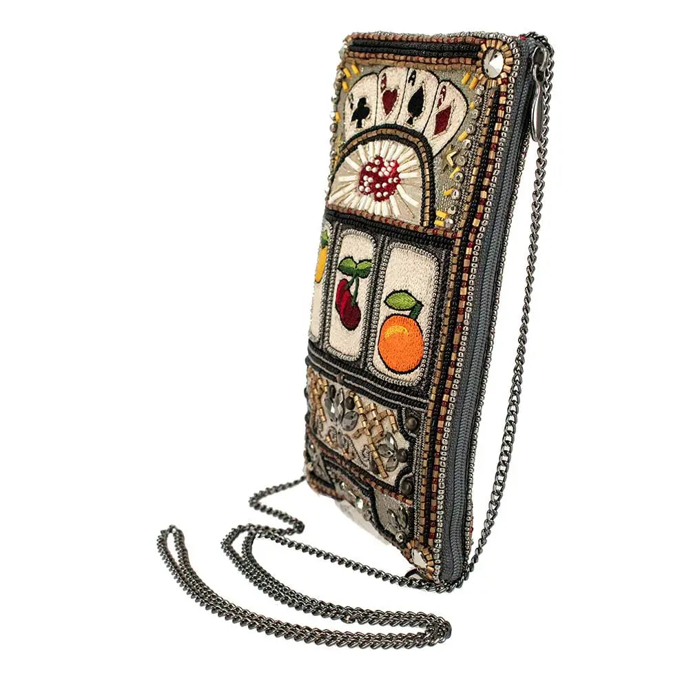 A beaded crossbody phone bag designed to resemble a slot machine with various symbols, including cards and fruits, displayed on the front.