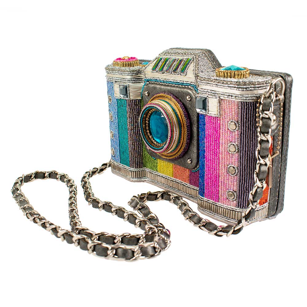 Colorful camera-shaped handbag with a chain strap on a white background