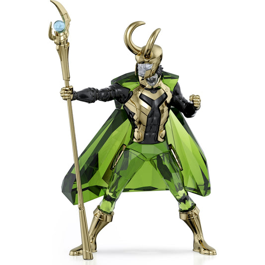 A toy figurine of Loki from Marvel with a green cape, gold armor, and a staff.