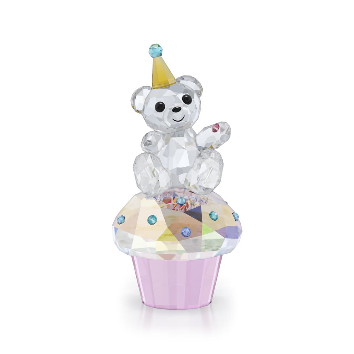 Crystal bear figurine on a cupcake with a party hat on a white background