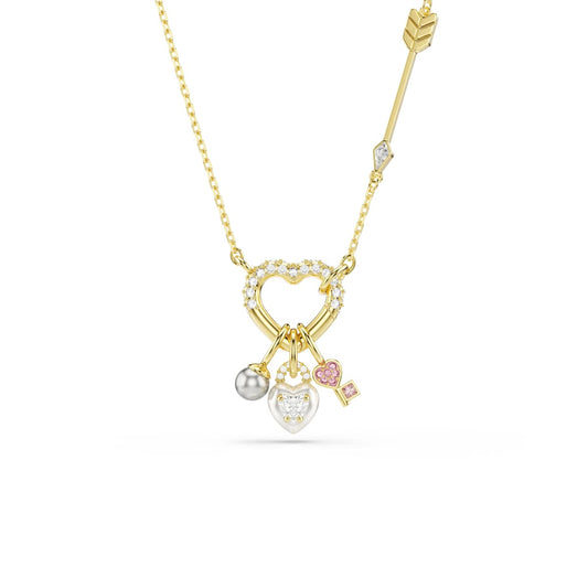 Gold tone necklace with heart-shaped pendant and three charms on a white background