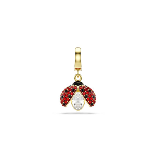 Gold tone charm with red and black gemstones on a white background