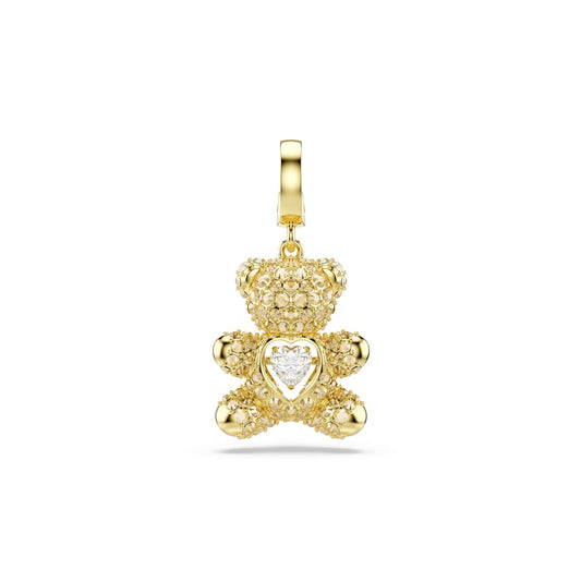 Gold tone teddy bear charm with a heart on a white background