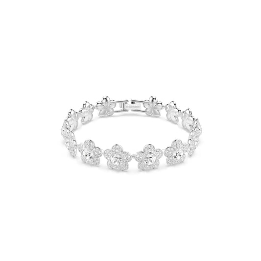 Silver bracelet with floral designs on a white background