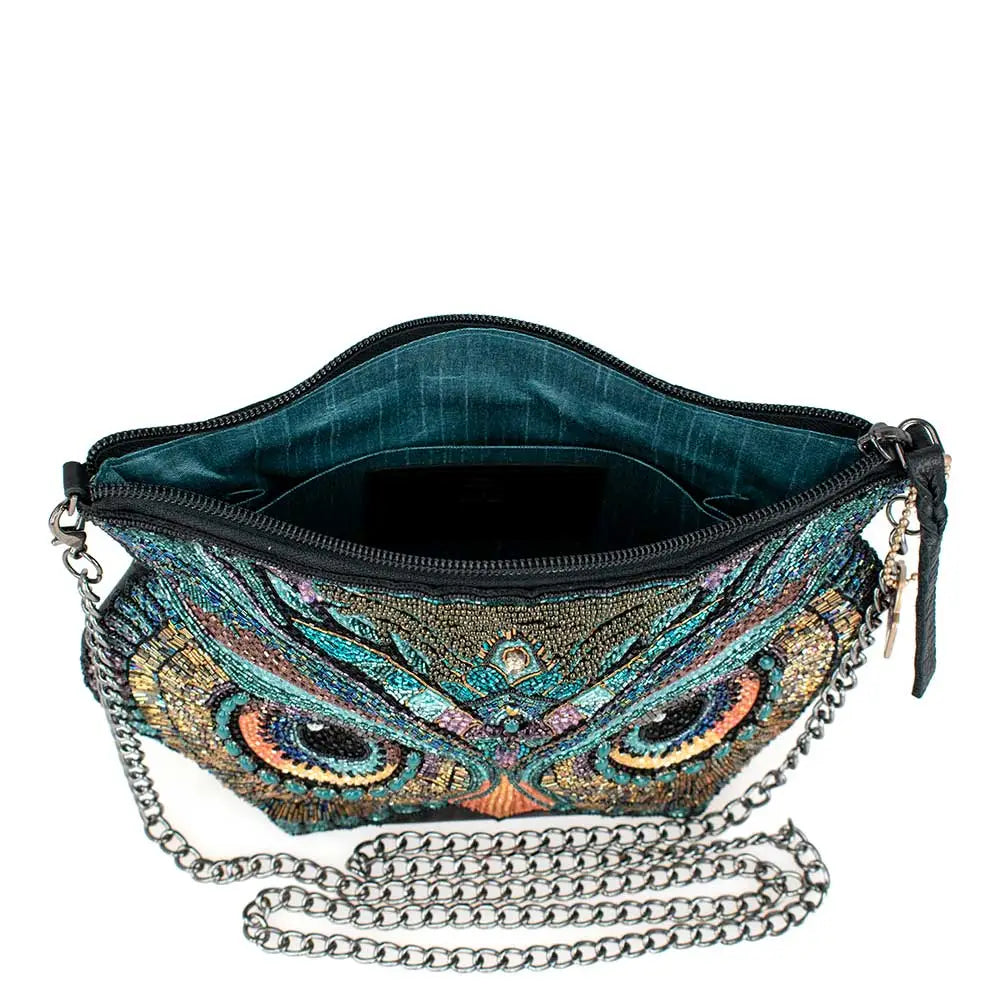 Colorful owl-themed handbag with chain strap on a white background.