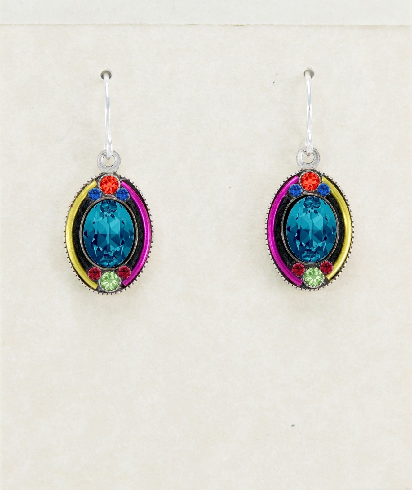 Pair of earrings with blue gemstones and colorful accents on a light background