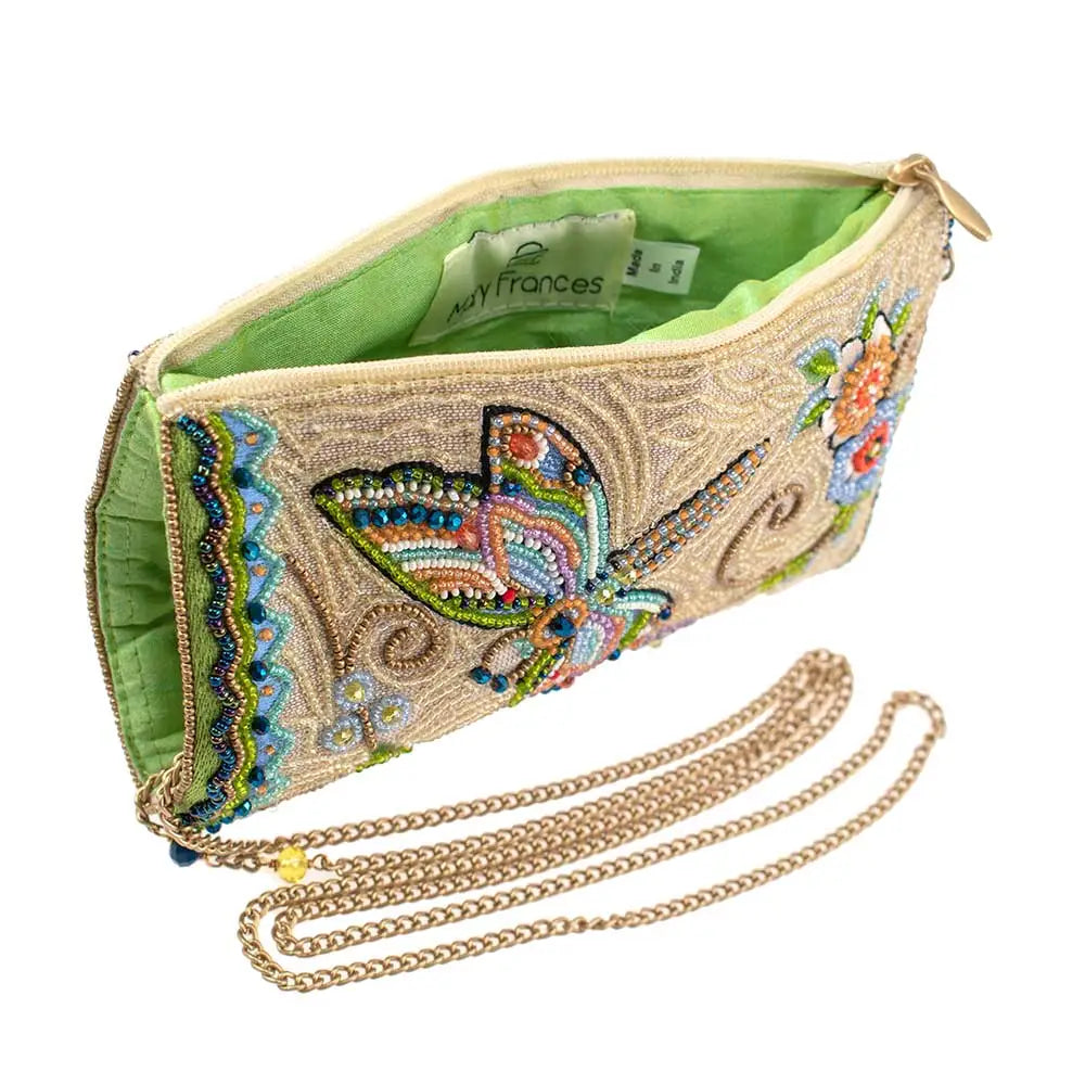 Decorative clutch bag with beaded design and chain strap on a white background