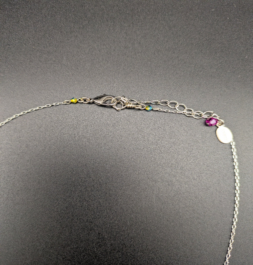 Multi color Firefly necklace on black background showing lobster clasp .