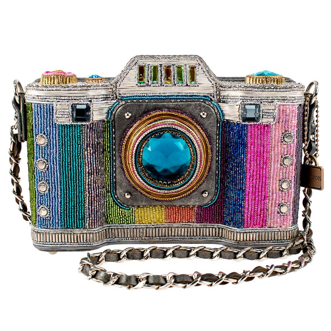 Colorful camera-shaped handbag with a chain strap on a white background