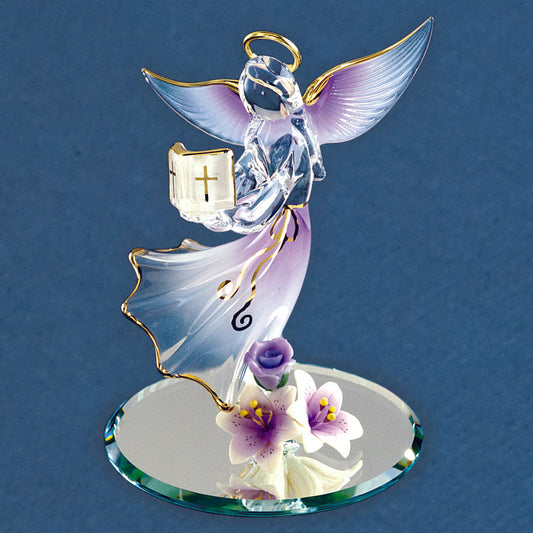 Crystal angel figurine with a cross on a blue background