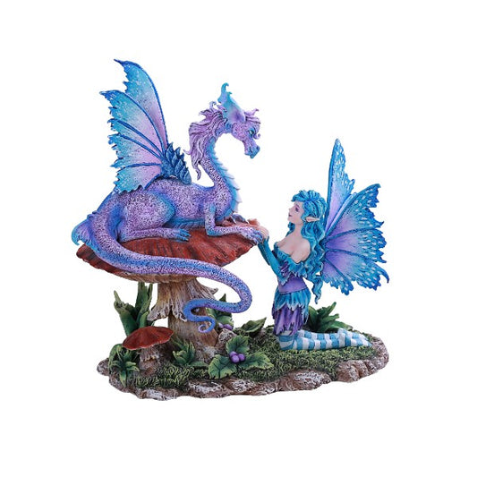 Fantasy figurine of a fairy and dragon on a mushroom with a white background