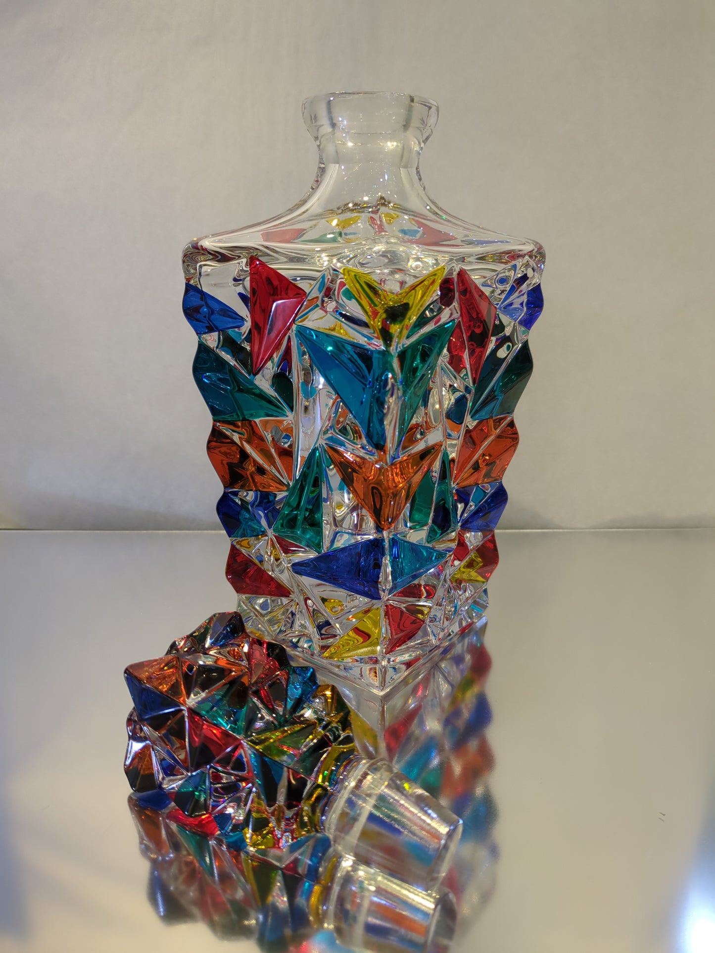 A colorful decanter and lid.