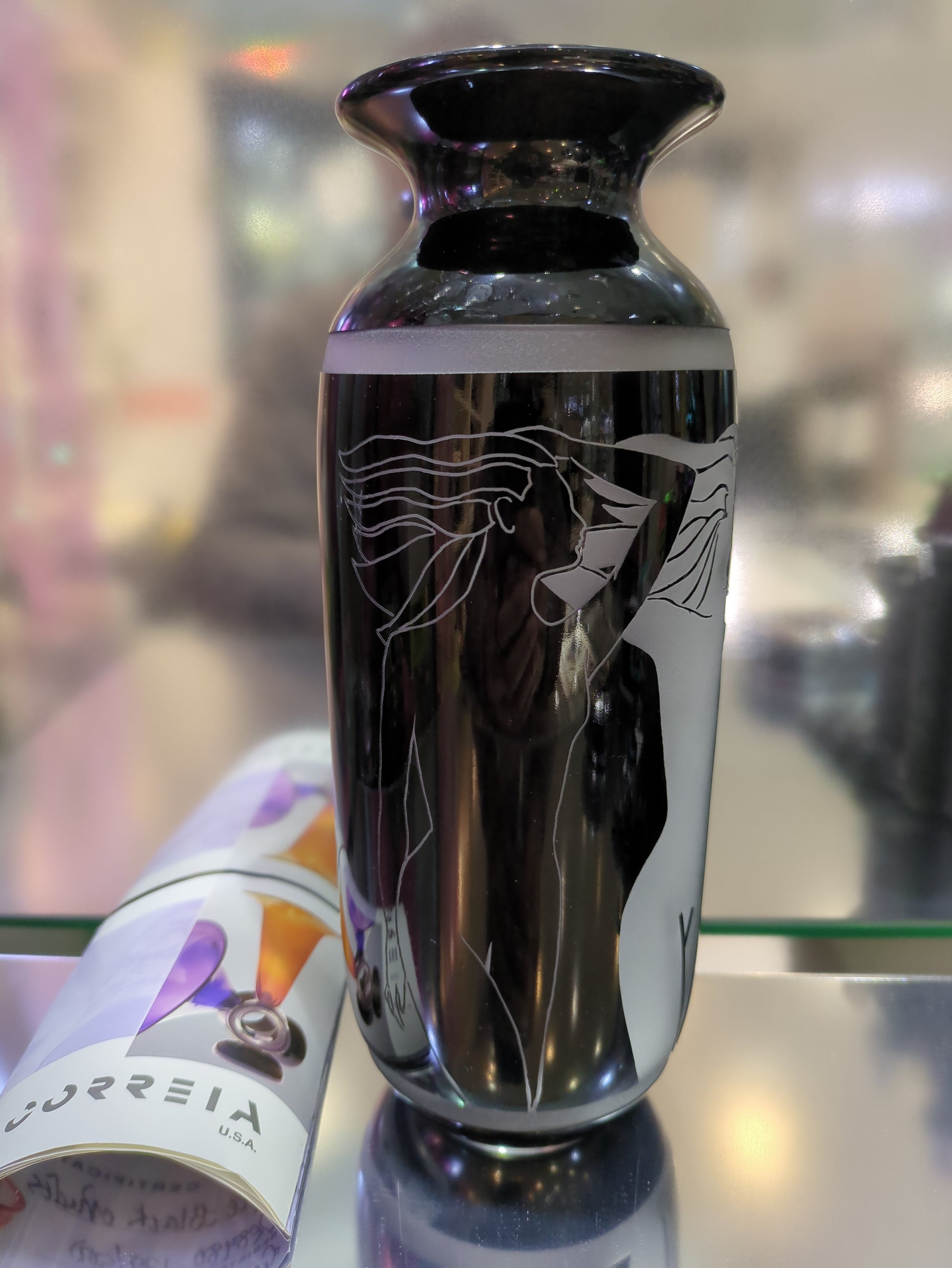 Decorative black vase with white patterns on a blurred background