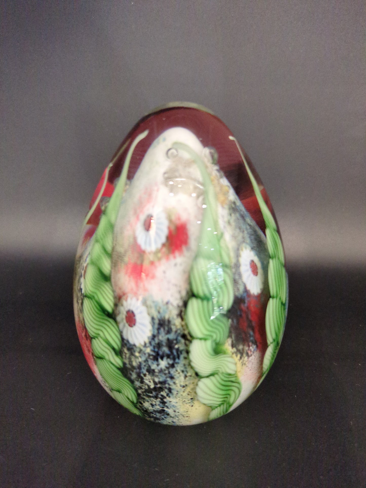 Decorative paperweight with floral patterns on a dark background