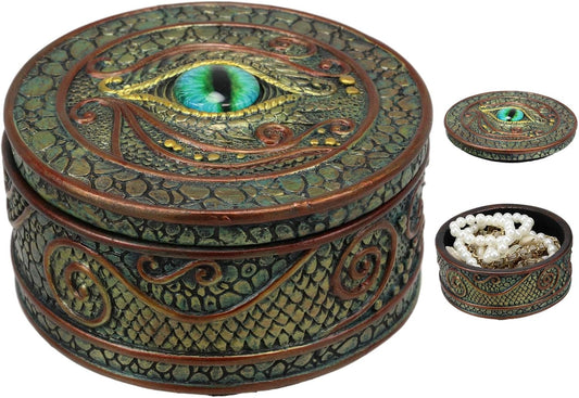 Decorative round box with eye design and smaller items on a white background