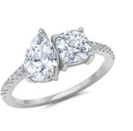 Silver ring with pear-shaped and round cut gemstones on a white background