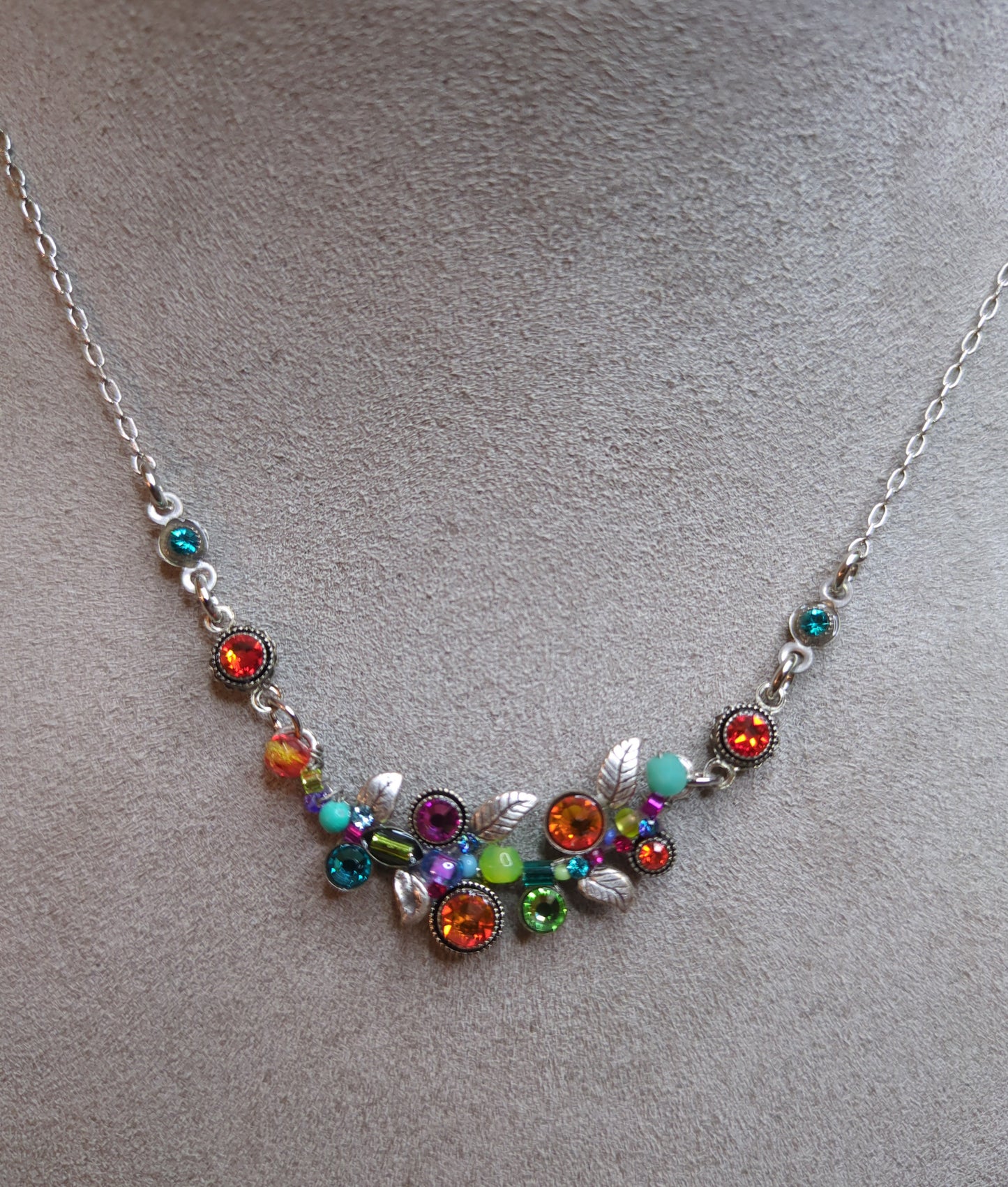 A colorful necklace with a cluster of multicolored crystals