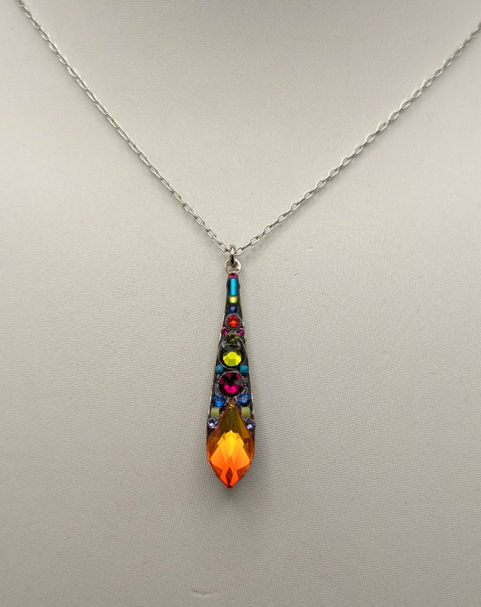 A silver chain necklace with a teardrop-shaped pendant featuring a colorful mosaic design, displayed on a white mannequin bust.
