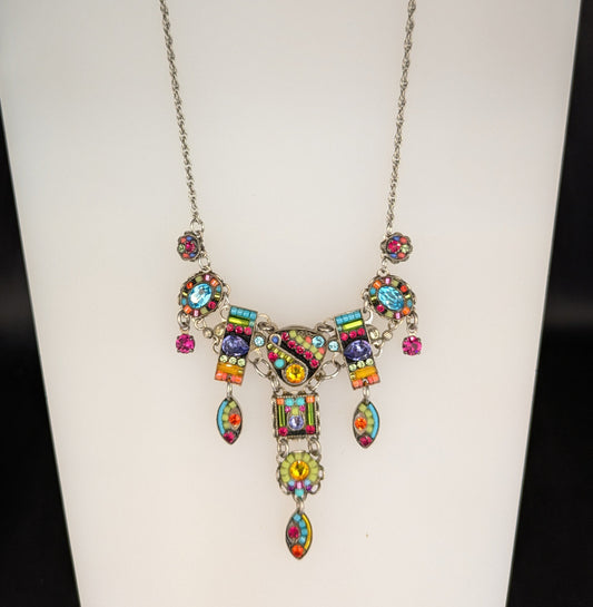 Colorful necklace on a mannequin bust against a white background