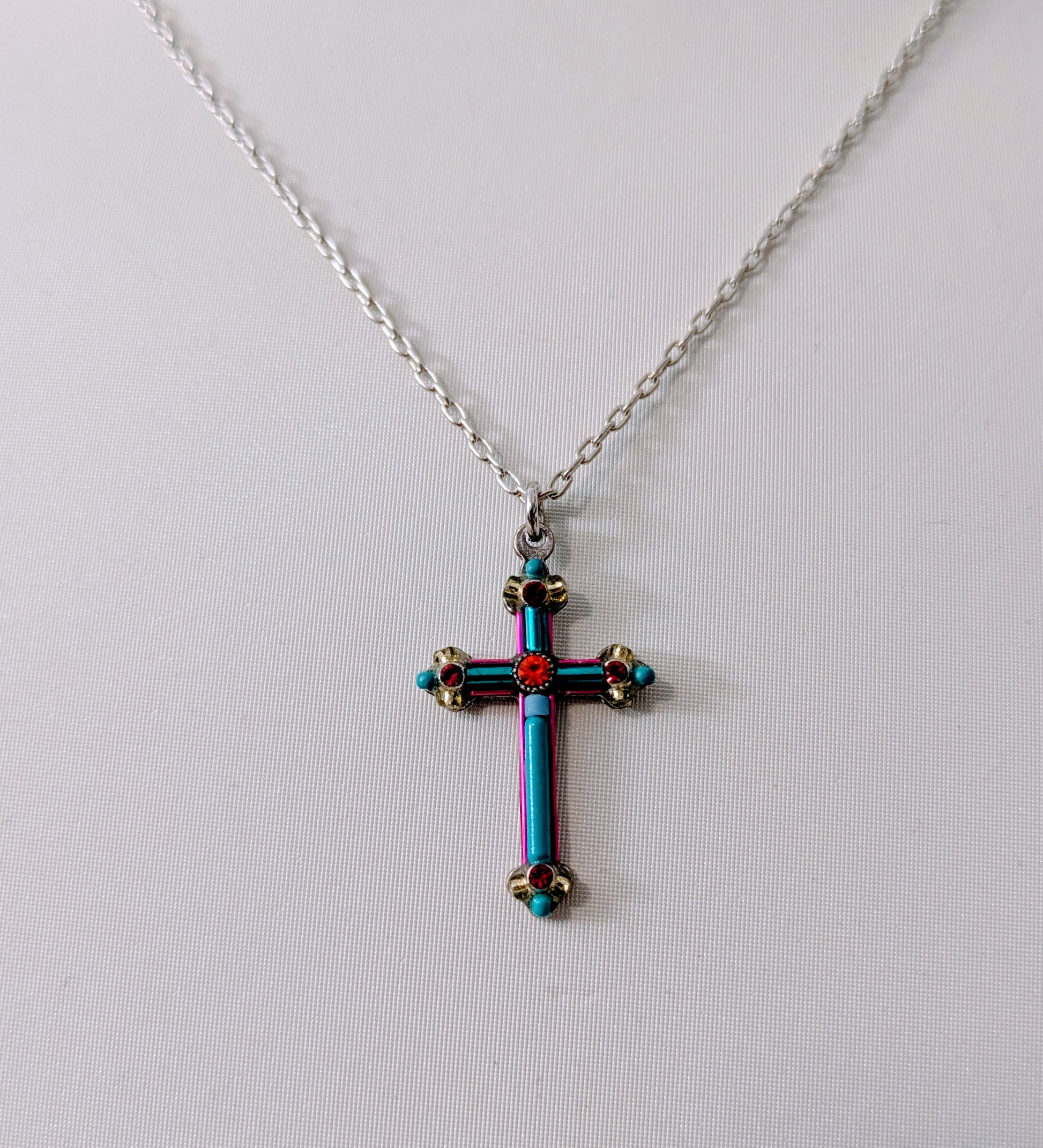 Cross-shaped pendant necklace with colorful design on a white background