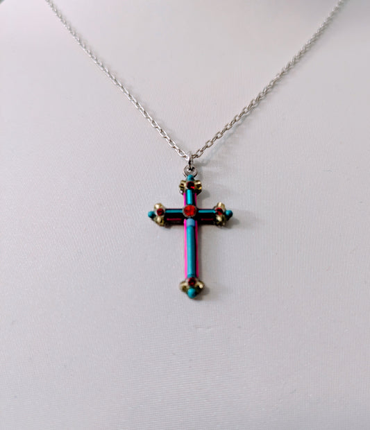 Multicolored cross pendant on a silver tone chain against a white background