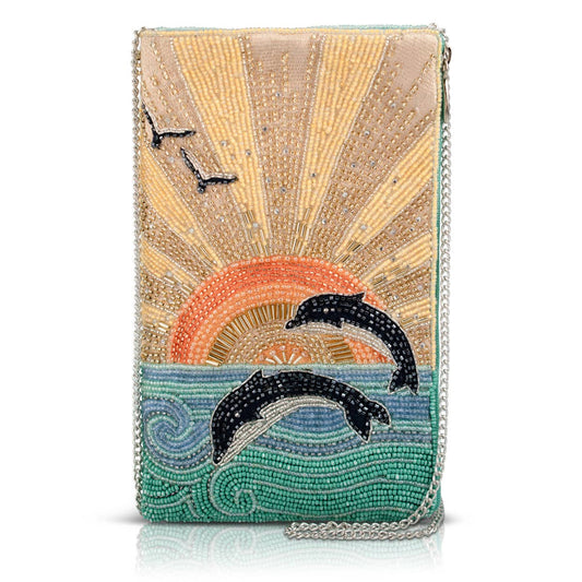 Beaded clutch with dolphins and sunset design on a white background