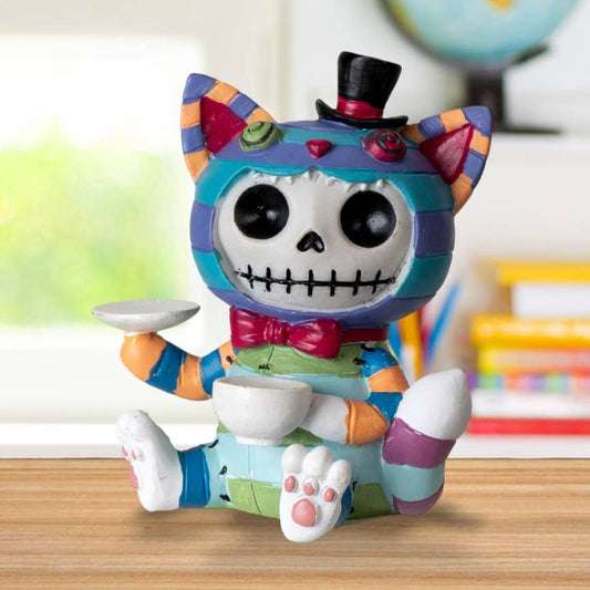 Colorful skeleton cat figurine with a top hat on a wooden surface