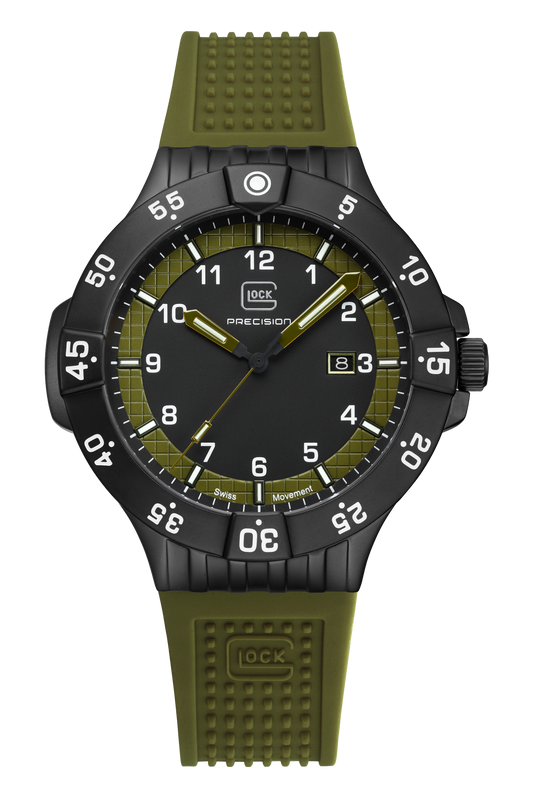 A wristwatch with an olive green textured silicone strap, a black case, and a black dial featuring white Arabic numerals and an olive green ring around the inner dial.