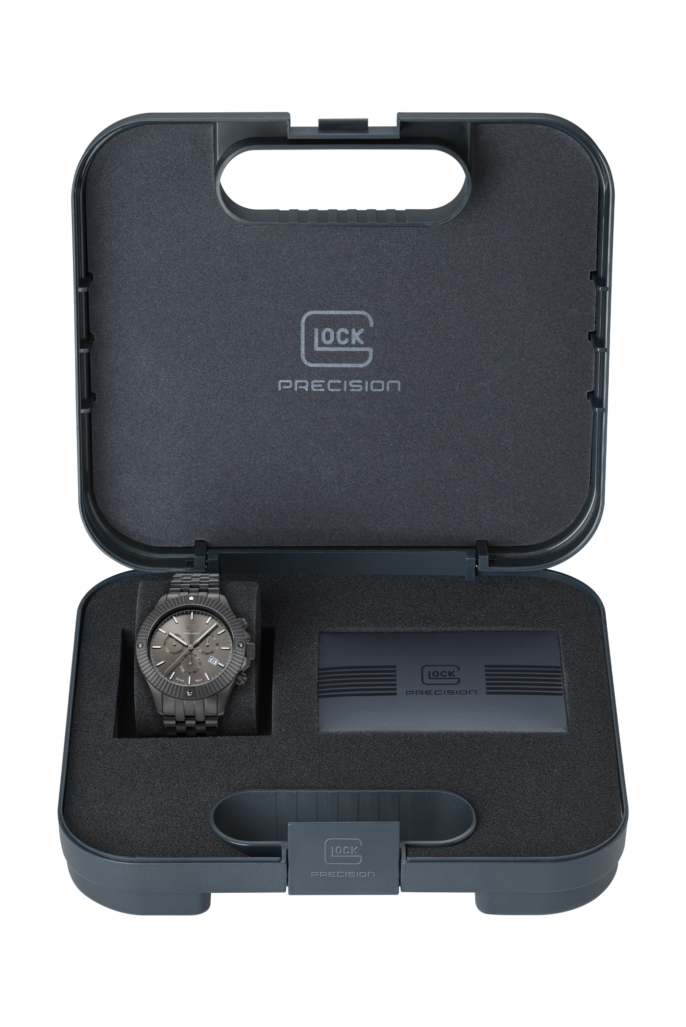 A Glock Precision watch with a dark gray wood-grain case and dial, presented inside its open dark gray foam storage case alongside a battery.