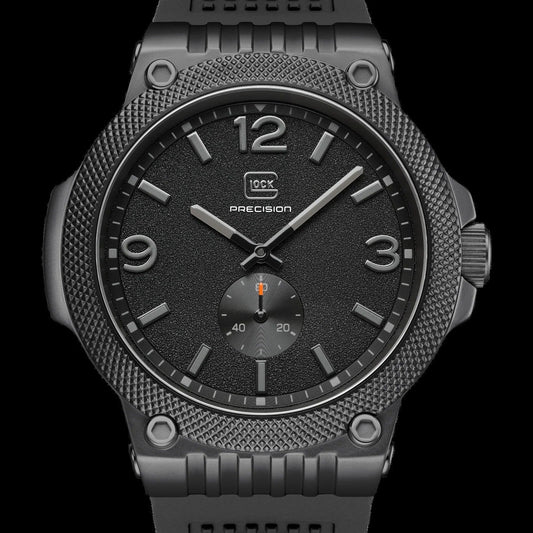 A rugged black tactical watch with a textured bezel, black dial, and black textured strap, shown against a solid black background.