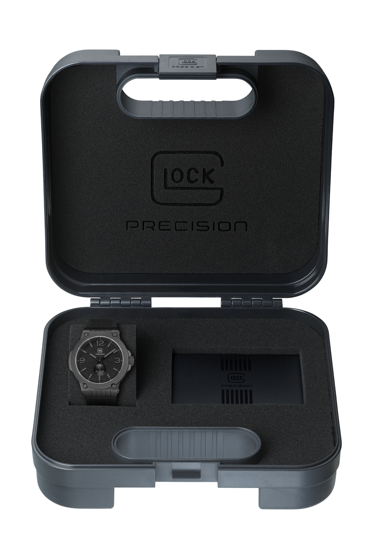 A precision watch presented in an open gray protective carrying case with black foam insert. The watch has a dark gray strap and a black dial with silver-tone hands and markers.
