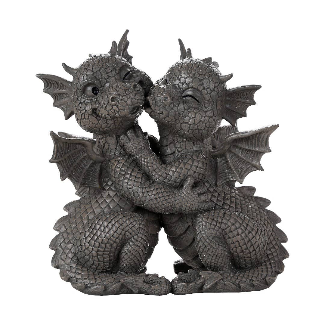 Two dragon figurines embracing on a white background