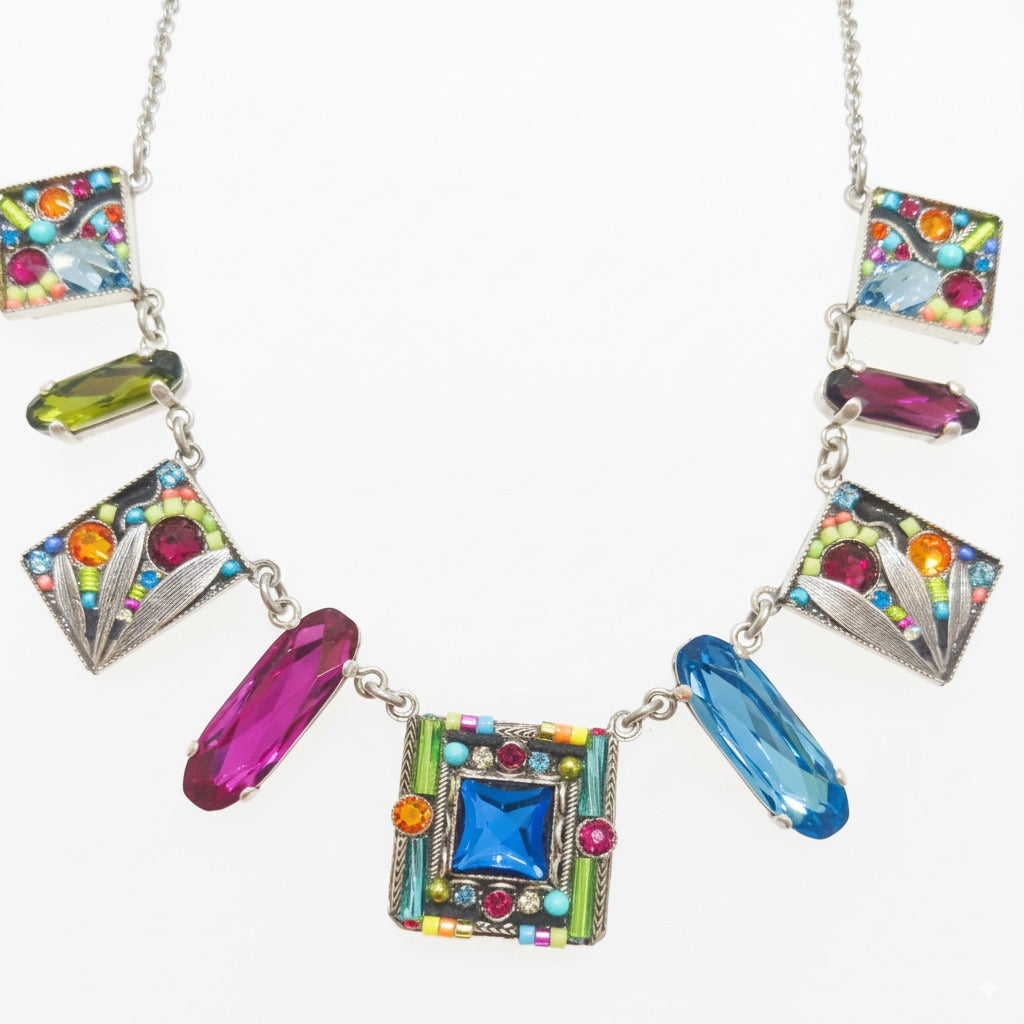 Colorful necklace with square and rectangular gemstones on a white background